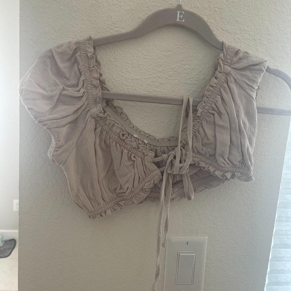 Garage cropped tan short sleeve top with adjustable ties in the front